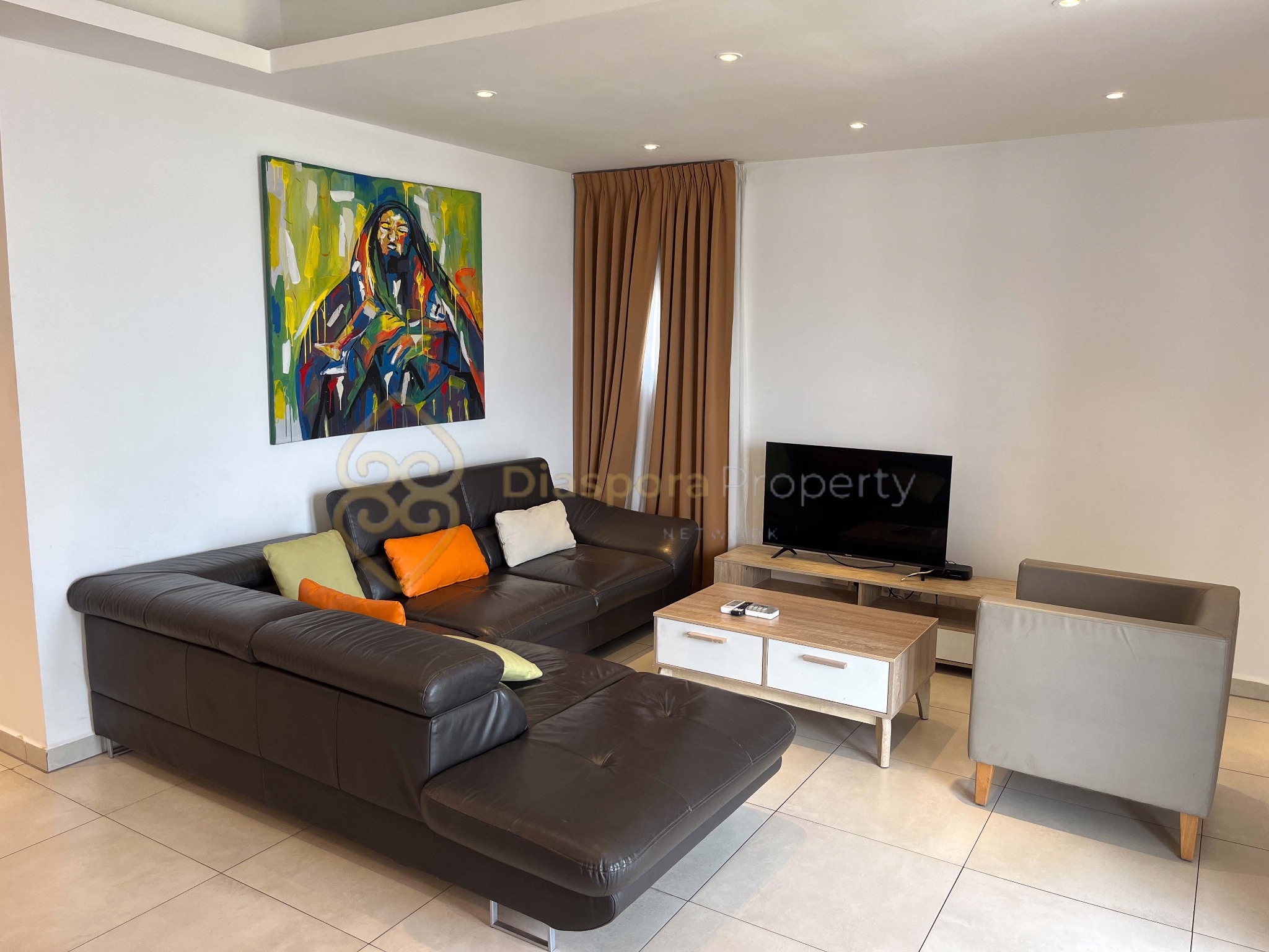 Living room with a sofa, coffee table and television